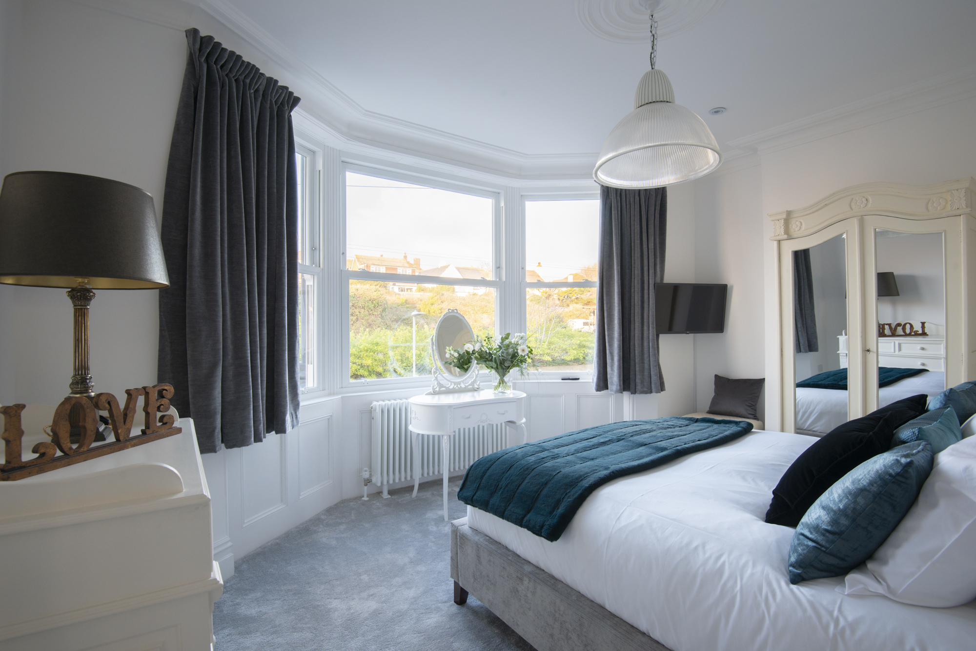 Bedroom 2 — king bed with bay window and garden views
